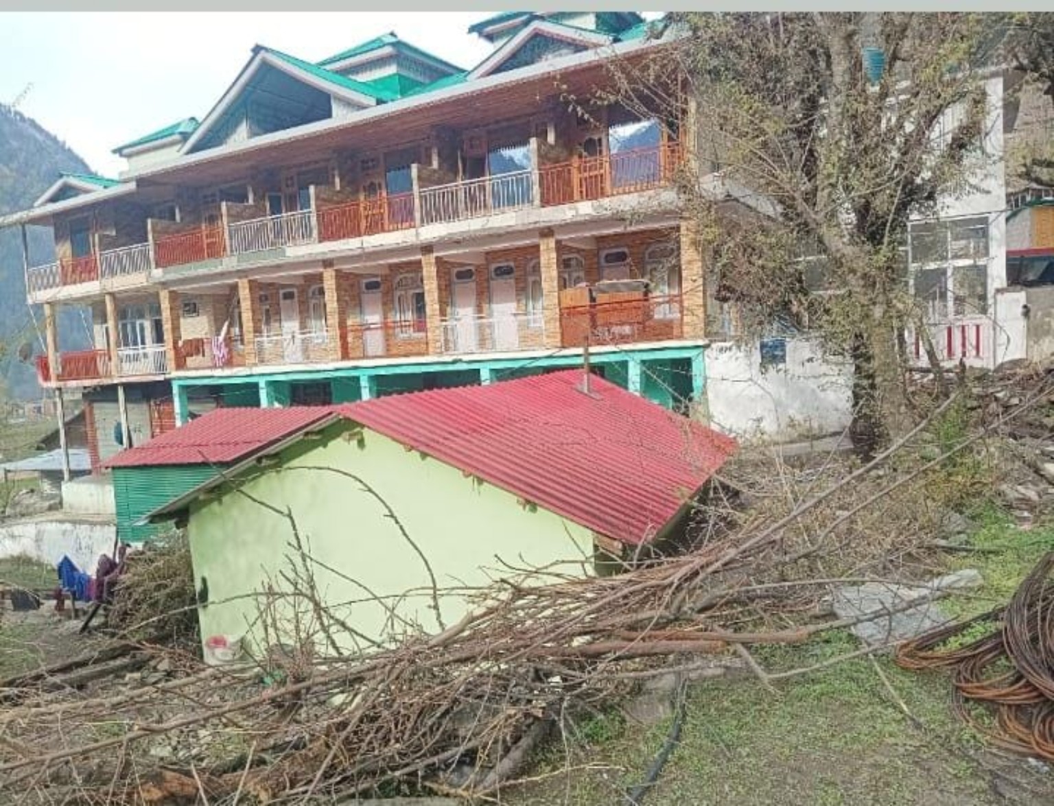 Sunset Homestay exterior with balconies and mountain surroundings